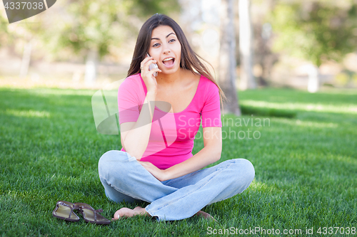 Image of Beautiful Young Ethnic Woman Talking on Her Smartphone Outside.