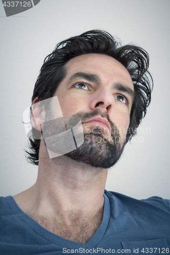 Image of bearded man looking upwards