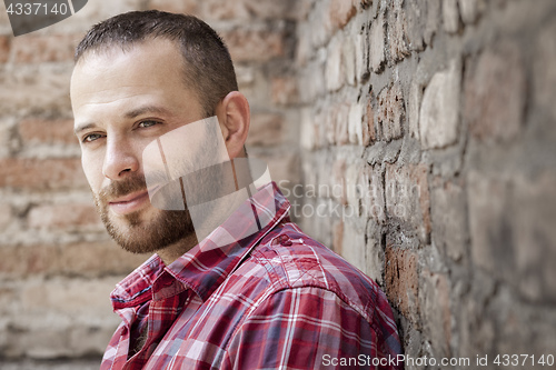 Image of bearded man at the brick wall