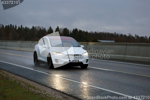 Image of White Tesla Model X Electric Car on Evening Road