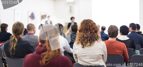 Image of Woman giving presentation on business conference.