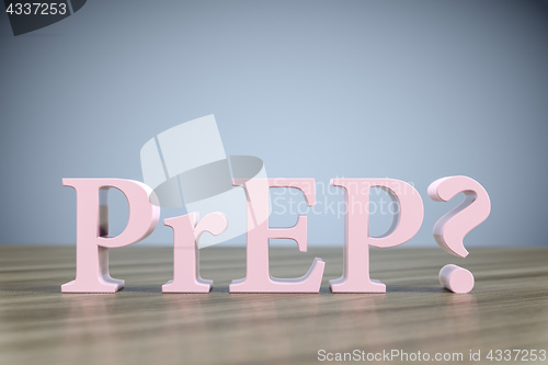 Image of the letters PrEP? on a wooden table