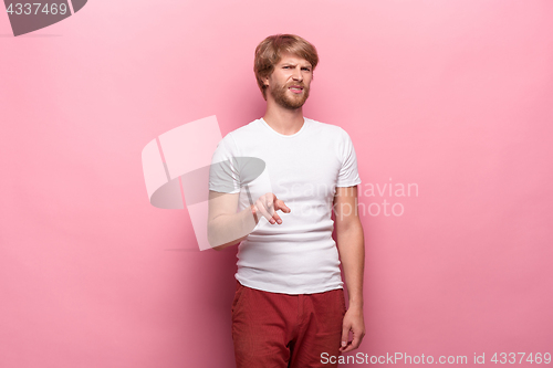 Image of Negative human facial expressions, emotions and feelings. Portrait of squeamish disgusted young man