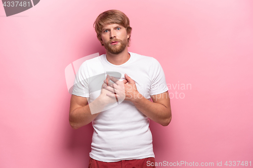 Image of Portrait of young man with shocked facial expression