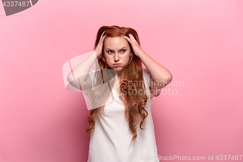 Image of The beautiful woman is offended on pink studio