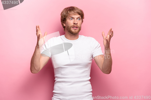 Image of Portrait of young man with shocked facial expression