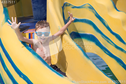 Image of happy child playing on the swimming pool at the day time.