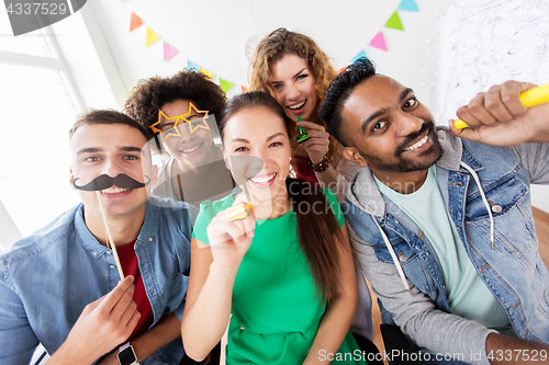 Image of happy friends or team having fun at office party