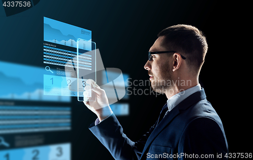 Image of businessman with tablet pc and exchange charts