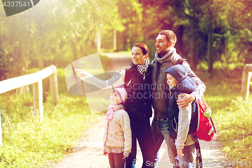 Image of happy family with backpacks hiking