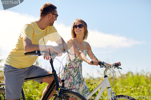 Image of happy couple with bicycles at country