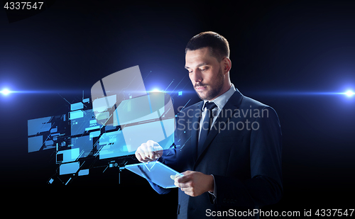 Image of businessman with tablet pc and virtual screens