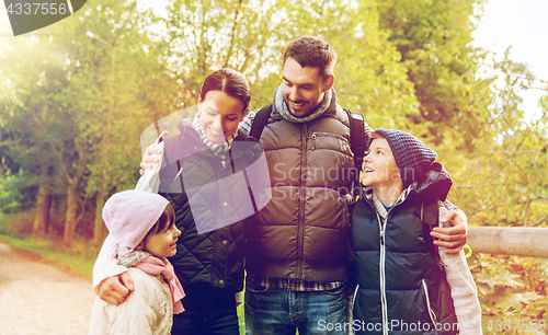 Image of happy family with backpacks hiking