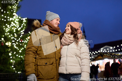 Image of happy couple talking at christmas tree