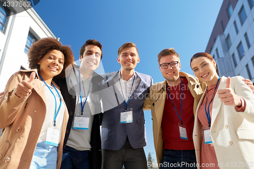 Image of business team with conference badges in city