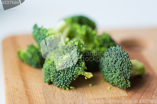 Image of close up of broccoli on wooden cutting board