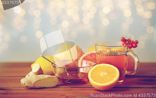 Image of tea with honey, lemon and ginger on wood