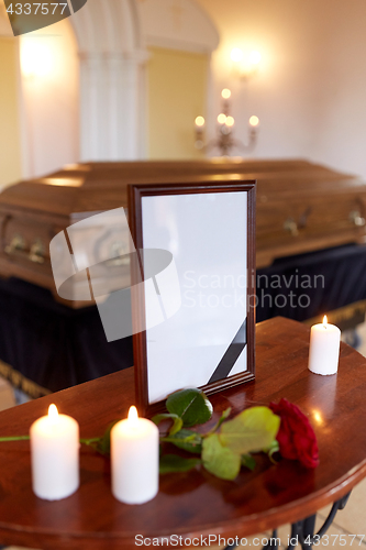 Image of photo frame and coffin at funeral in church