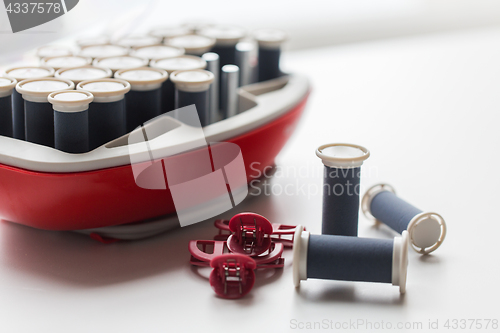 Image of hot rollers kit on table with hair clips