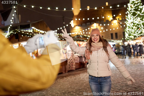 Image of happy woman posing for smartphone at christmas