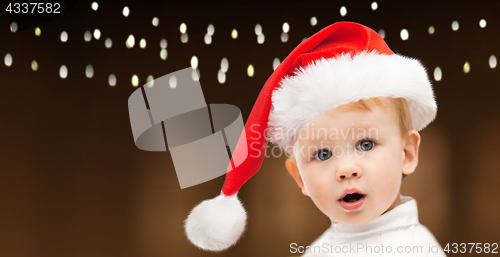 Image of little baby boy in santa hat at christmas