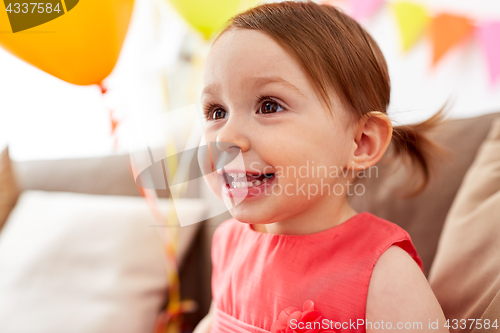 Image of happy baby girl on birthday party at home