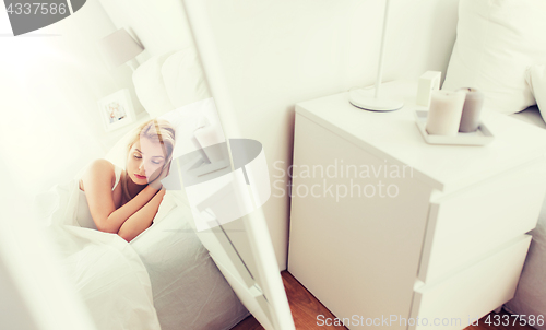 Image of young woman sleeping in bed at home bedroom