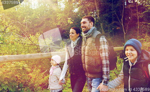 Image of happy family with backpacks hiking