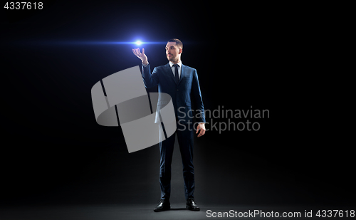 Image of businessman with laser light over black