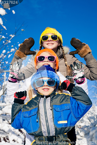 Image of Happy little children playing  in winter snow day.