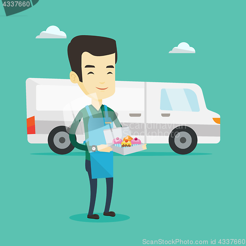 Image of Delivery man holding a box of cakes.