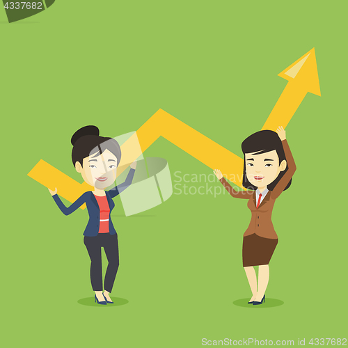 Image of Two business women holding growth graph.