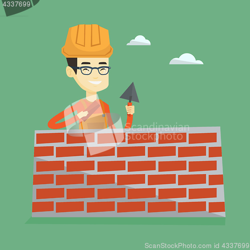 Image of Bricklayer working with spatula and brick.