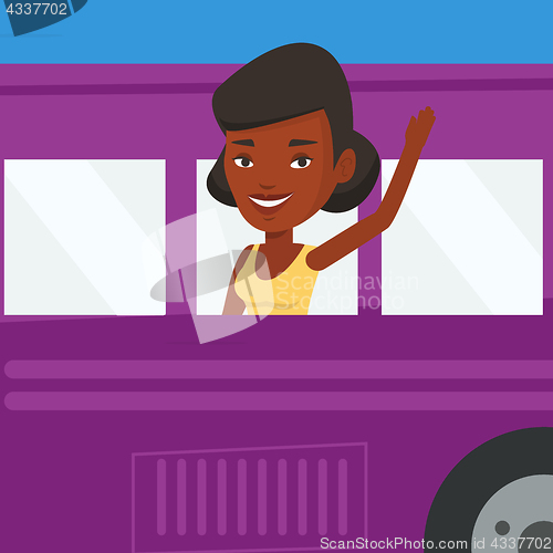 Image of Woman waving hand from bus window.