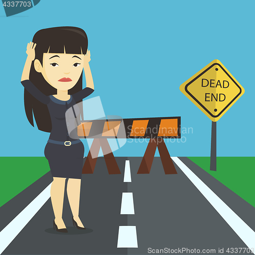 Image of Business woman looking at road sign dead end.