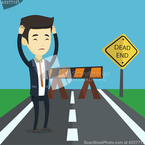 Image of Business man looking at road sign dead end.