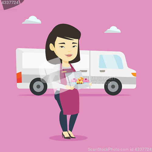 Image of Delivery woman holding a box of cakes.