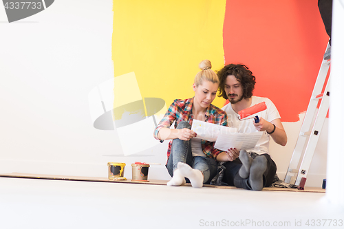 Image of Happy young couple relaxing after painting