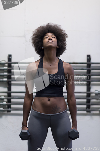 Image of black woman doing bicep curls