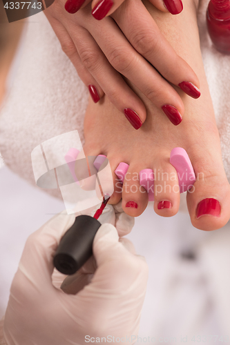 Image of female feet and hands at spa salon