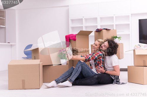 Image of young couple moving  in new house