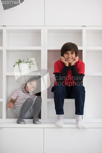 Image of young boys posing on a shelf