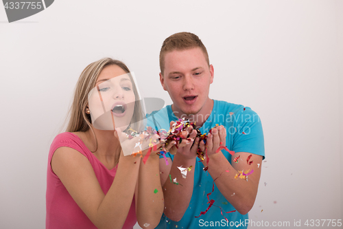 Image of romantic young  couple celebrating  party with confetti