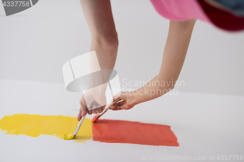 Image of couple painting interior wall