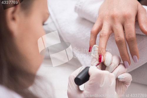 Image of Woman hands receiving a manicure