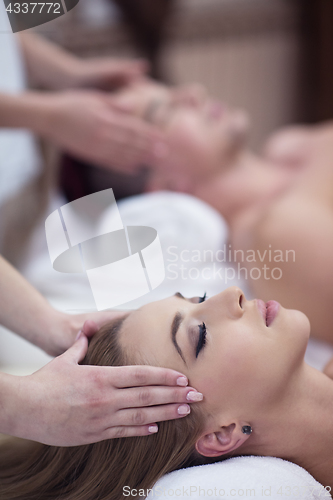 Image of couple enjoying head massage at the spa