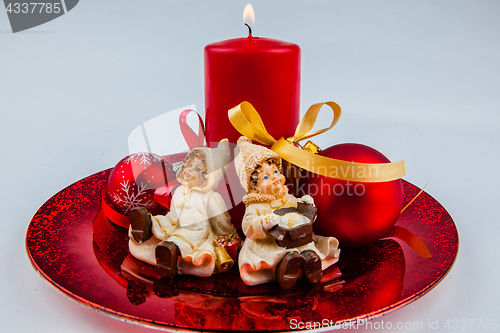 Image of Christmas decorated barrels with bullets, candles, winter clothe