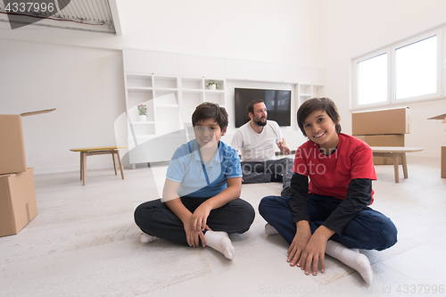 Image of portrait of happy young boys with their dad