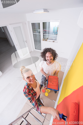 Image of couple painting interior wall