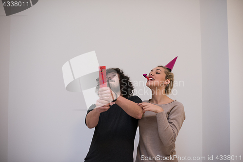 Image of romantic young  couple celebrating  party with confetti